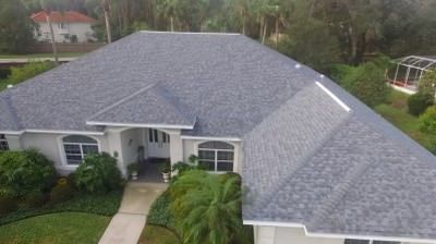 Aerial view of a completed grey shingle reroof on a Palm Coast home